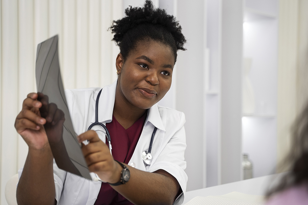 X-ray technician operating advanced medical imaging equipment